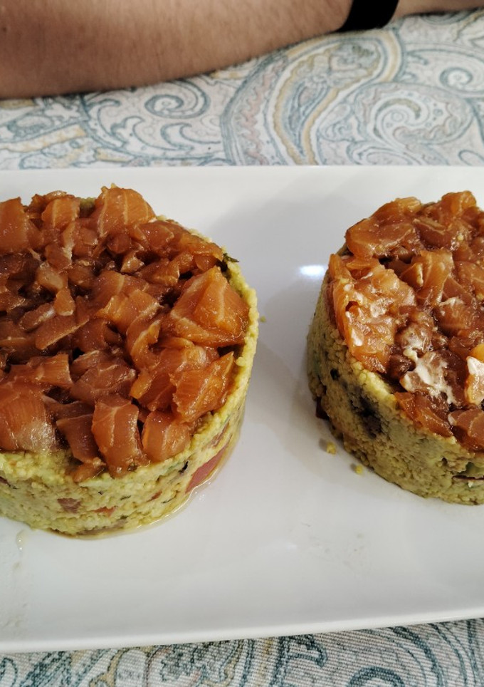 Una foto de Tartar de salmón y anchoas con base de cuscús y salsa de mayonesa y mostaza