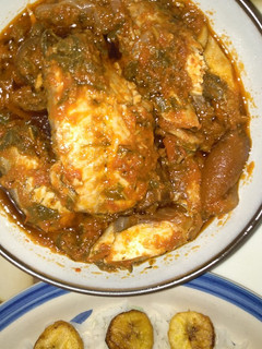 A picture of Spinach stew with smoked fish and pomo (cowskin).