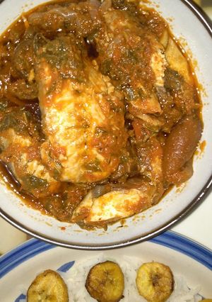 A picture of Spinach stew with smoked fish and pomo (cowskin).