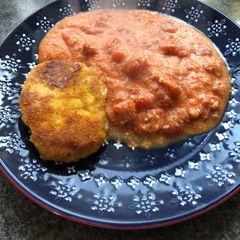 Mother’s pork steak in breadcrumbs with cheese and tomatoes A picture of Mother’s pork steak in breadcrumbs with cheese and tomatoes.