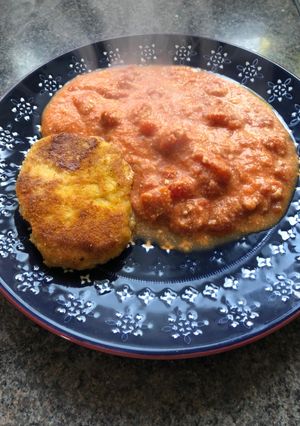 A picture of Mother’s pork steak in breadcrumbs with cheese and tomatoes.