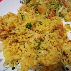 A picture of Spicy tumeric rice with chicken strips.
