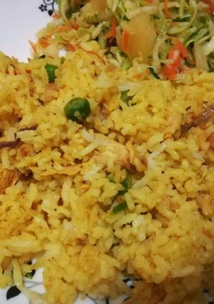 A picture of Spicy tumeric rice with chicken strips.