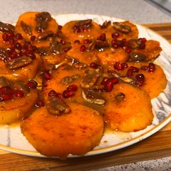 A picture of Glazed sweet potatoes with pomegranate & pecans.