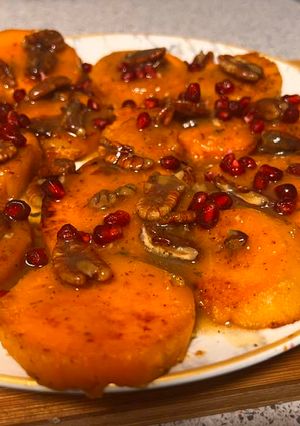 A picture of Glazed sweet potatoes with pomegranate & pecans.