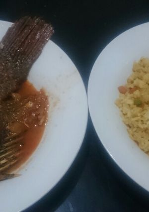 A picture of Fried fish and veg rice.