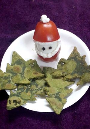 A picture of Tomato santa with spinach Christmas trees.