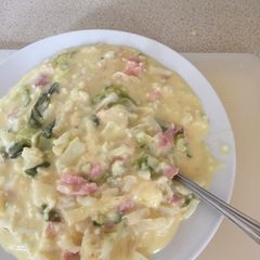A picture of Cauliflower Cheese with Bacon bits.