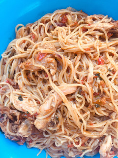 A picture of Spaghetti jollof with shredded chicken.