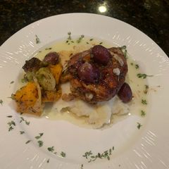 A picture of Rosemary Chicken Thighs w Roasted Grapes and Smashed Parsnips.