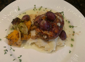 A picture of Rosemary Chicken Thighs w Roasted Grapes and Smashed Parsnips.