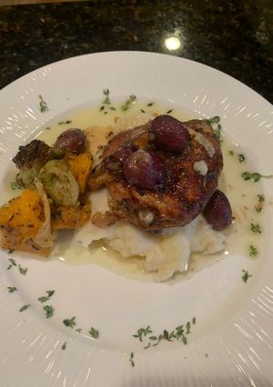 A picture of Rosemary Chicken Thighs w Roasted Grapes and Smashed Parsnips.