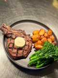Rib eye on the bone, brocollini, and smoked paprika chat potato