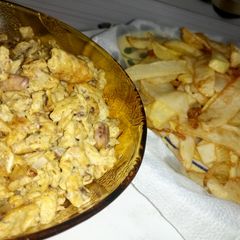 A picture of Chips and scramble egg with sardine.