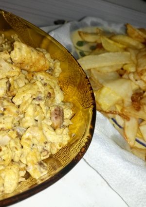 A picture of Chips and scramble egg with sardine.