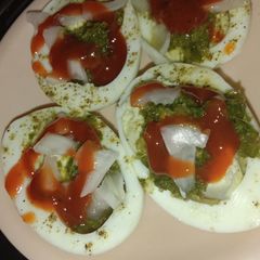 A picture of Boiled eggs with chutney.