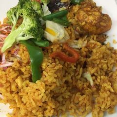 A picture of Chicken/fish jollof with vegetables.