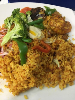 A picture of Chicken/fish jollof with vegetables.