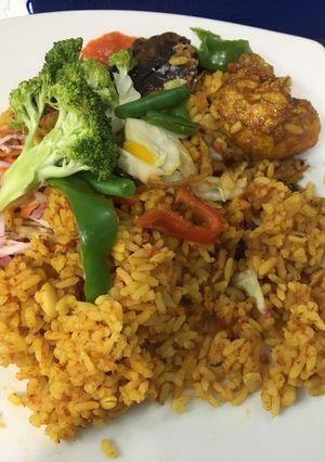 A picture of Chicken/fish jollof with vegetables.