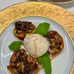 A picture of Baked Peaches with Amaretti, Dark Chocolate, Ice Cream and Mint.