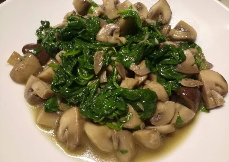 Sauteed mushrooms and wilted spinach in garlic butter
