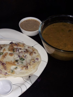 A picture of Onion Uthappam with sambar or chana dal peanut chutney.