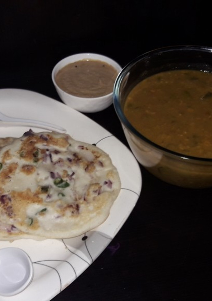 A picture of Onion Uthappam with sambar or chana dal peanut chutney.