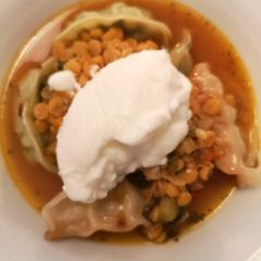 A picture of Yellow lentil stew with gyozas.