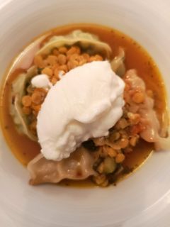 A picture of Yellow lentil stew with gyozas.