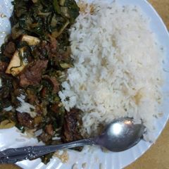 Coconut rice with spinach stew A picture of Coconut rice with spinach stew.