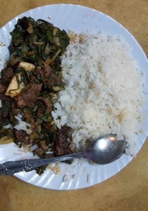 A picture of Coconut rice with spinach stew.