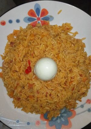 A picture of Jollof rice with boiled egg.