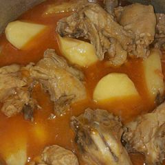 A picture of Chicken curry with beer.