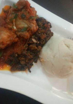 A picture of Pounded yam with vegetable soup.