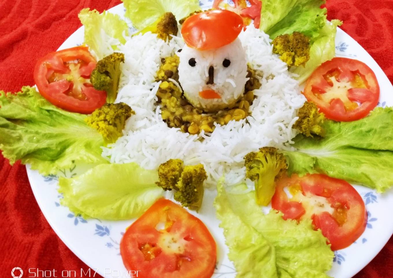 Egg shaped rice with dal and stir fried broccoli and tomato