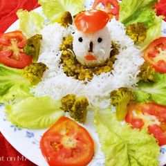 A picture of Egg shaped rice with dal and stir fried broccoli and tomato.