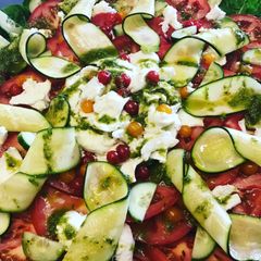 A picture of Beef tomato, mozzarella, pesto and curly courgette salad.