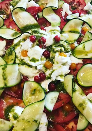 A picture of Beef tomato, mozzarella, pesto and curly courgette salad.