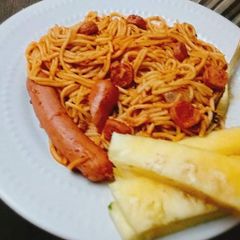 A picture of Pasta and sausages with pineapple.