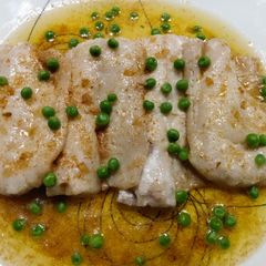 A picture of Poached pollock with brown butter and peas.