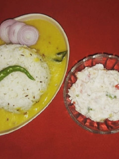 A picture of Dal Fry and Jeera Rice with mayonnaise salad.