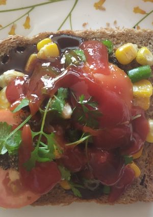 A picture of Open cheese corn and capsicum sandwich.