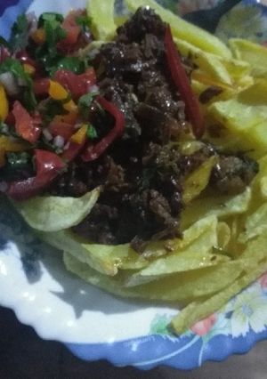 A picture of Fries and beef stew.