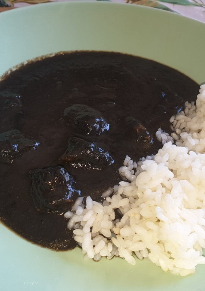 Una foto de Chipirones en su tinta con arroz blanco de acompañamiento