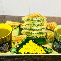 A picture of Spinach-Cheese Corns Grilled Sandwich With Mixed Veg Soup.