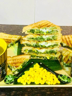 A picture of Spinach-Cheese Corns Grilled Sandwich With Mixed Veg Soup.