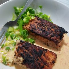 A picture of Pan roasted Salmon with creamy red pepper and jalapeno sauce.