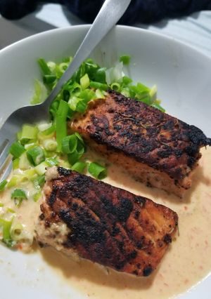 A picture of Pan roasted Salmon with creamy red pepper and jalapeno sauce.