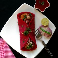 A picture of Chana dal seekh kebab in beet wrap.