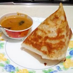 A picture of Roast cone dosa with moong dal sambar.